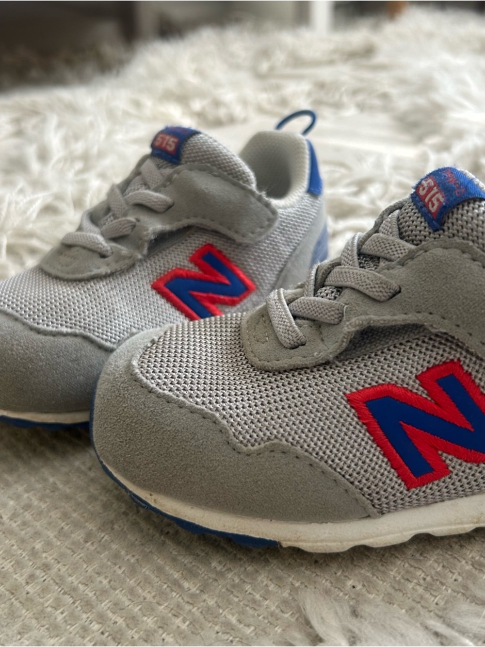 New Balance Kids Gray Sneakers with Blue and Red Accents